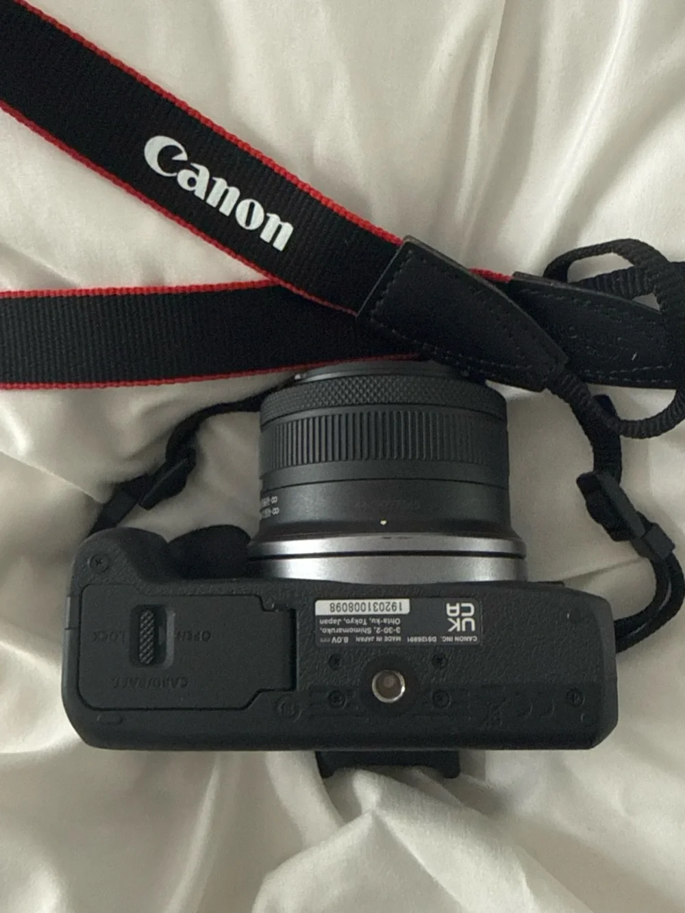 Canon EOS R100 Compact Mirrorless Camera with Red-Trim Strap – Black